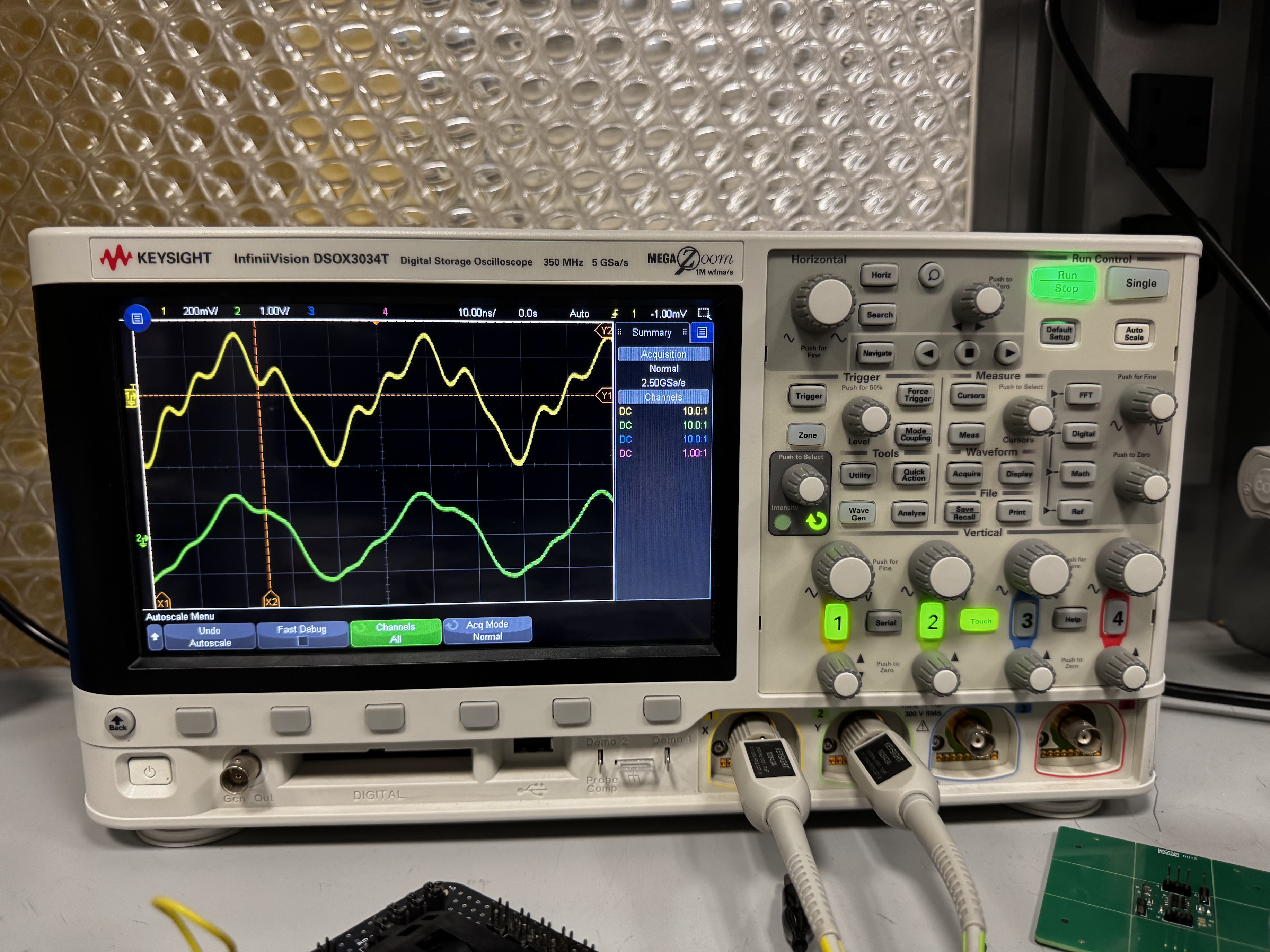 Probing the OmniStim during operational testing, the yellow is on the RX side and green is TX